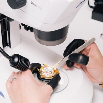 Specialist examining a luxury item to verify authenticity
